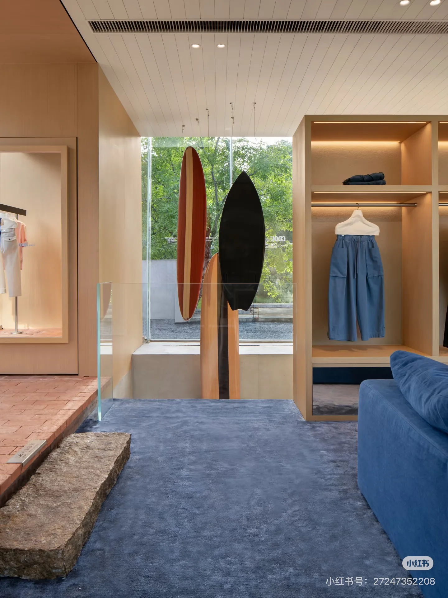 Surfboards, blue seating and clothing displays inside CDOU select.