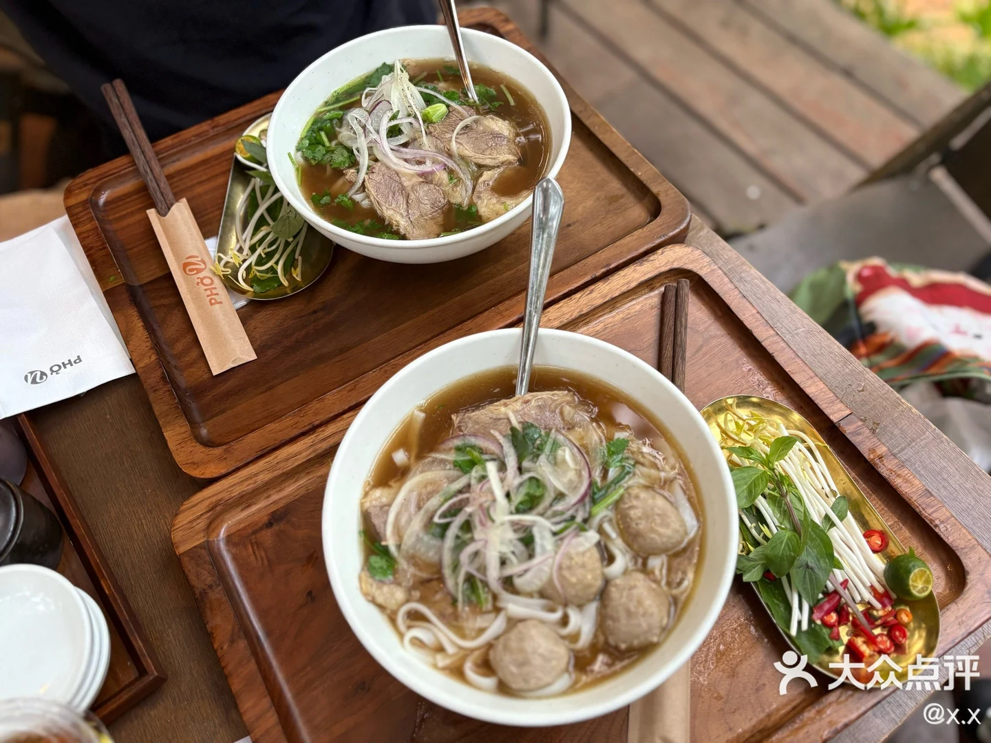 Two bowls of beef pho with fresh herbs at PHO U, photographed by Dianping user @x.x.