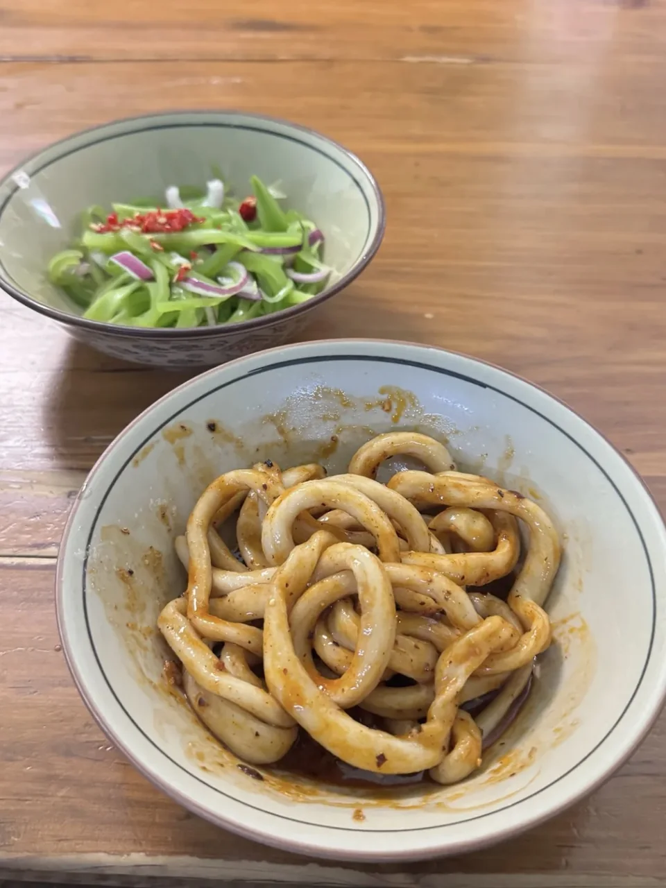 Sweet Water Noodles in a ceramic bowl with a side of sliced vegetables