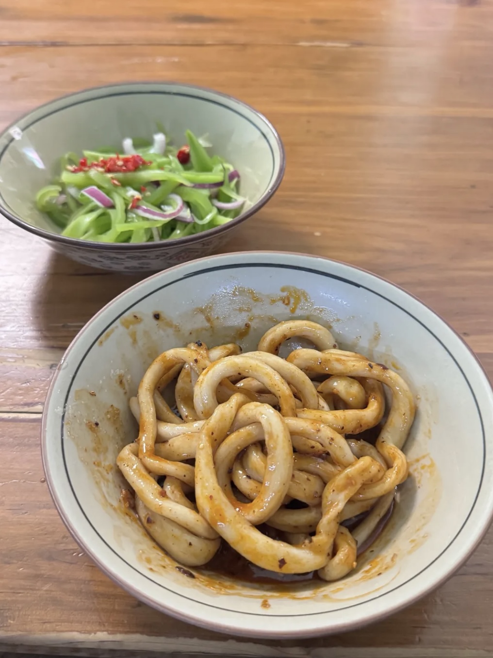 Sweet Water Noodles in a ceramic bowl with a side of sliced vegetables