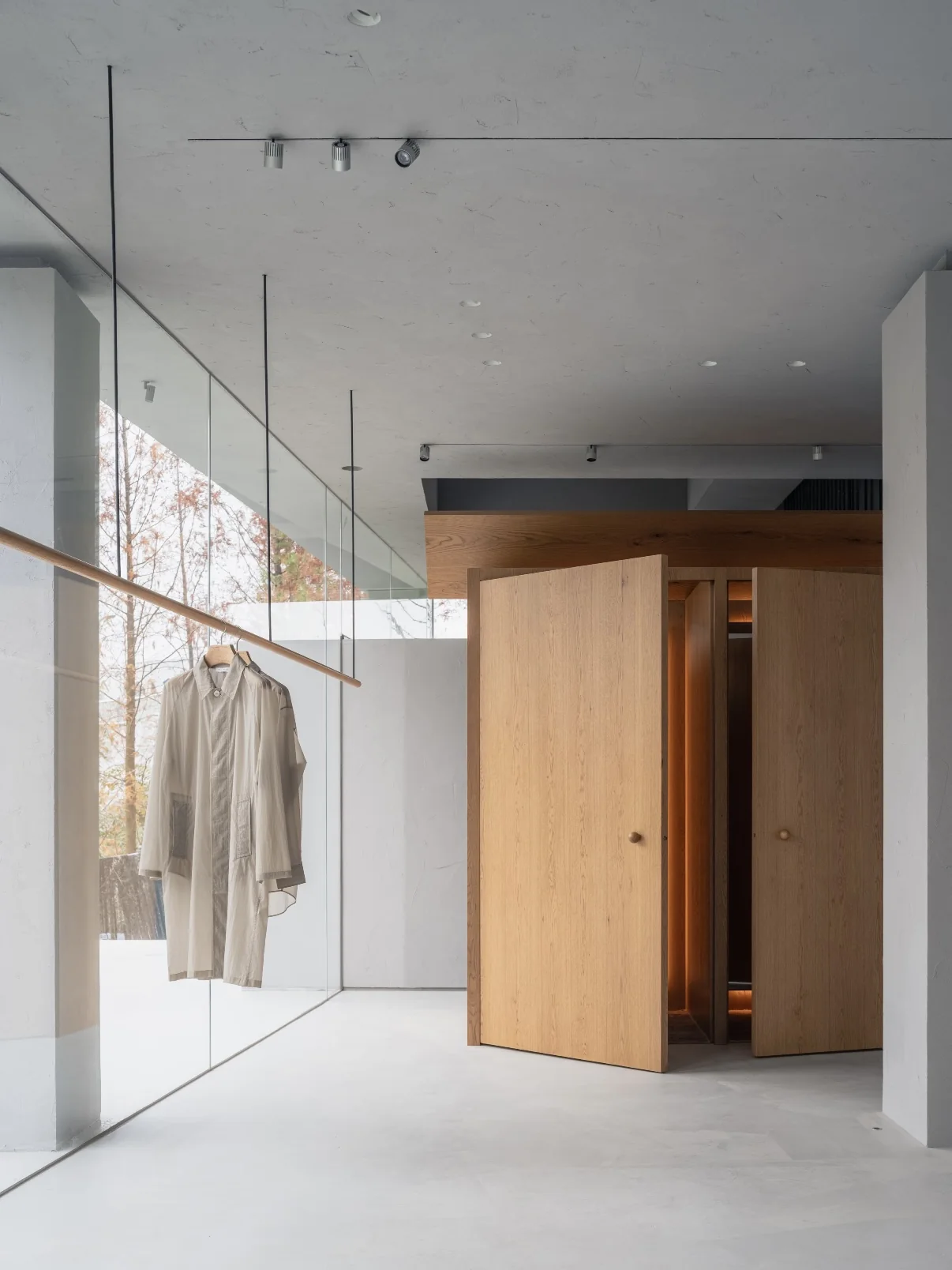 A clothing display and wooden doors inside YEARLY PLAN HOUSE.