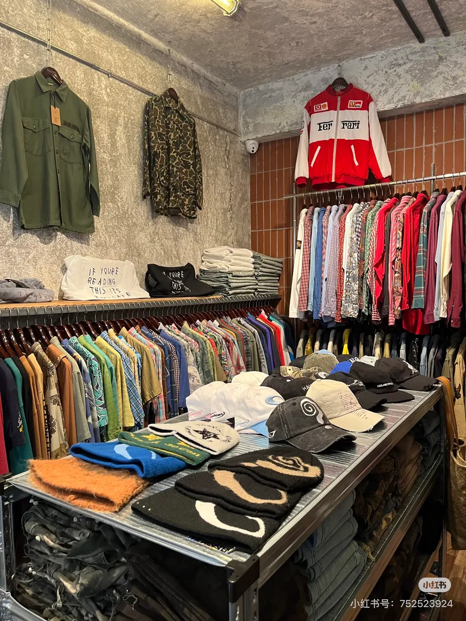 Shirts, jackets and hats displayed inside Meursault Union; original RedNote watermark retained