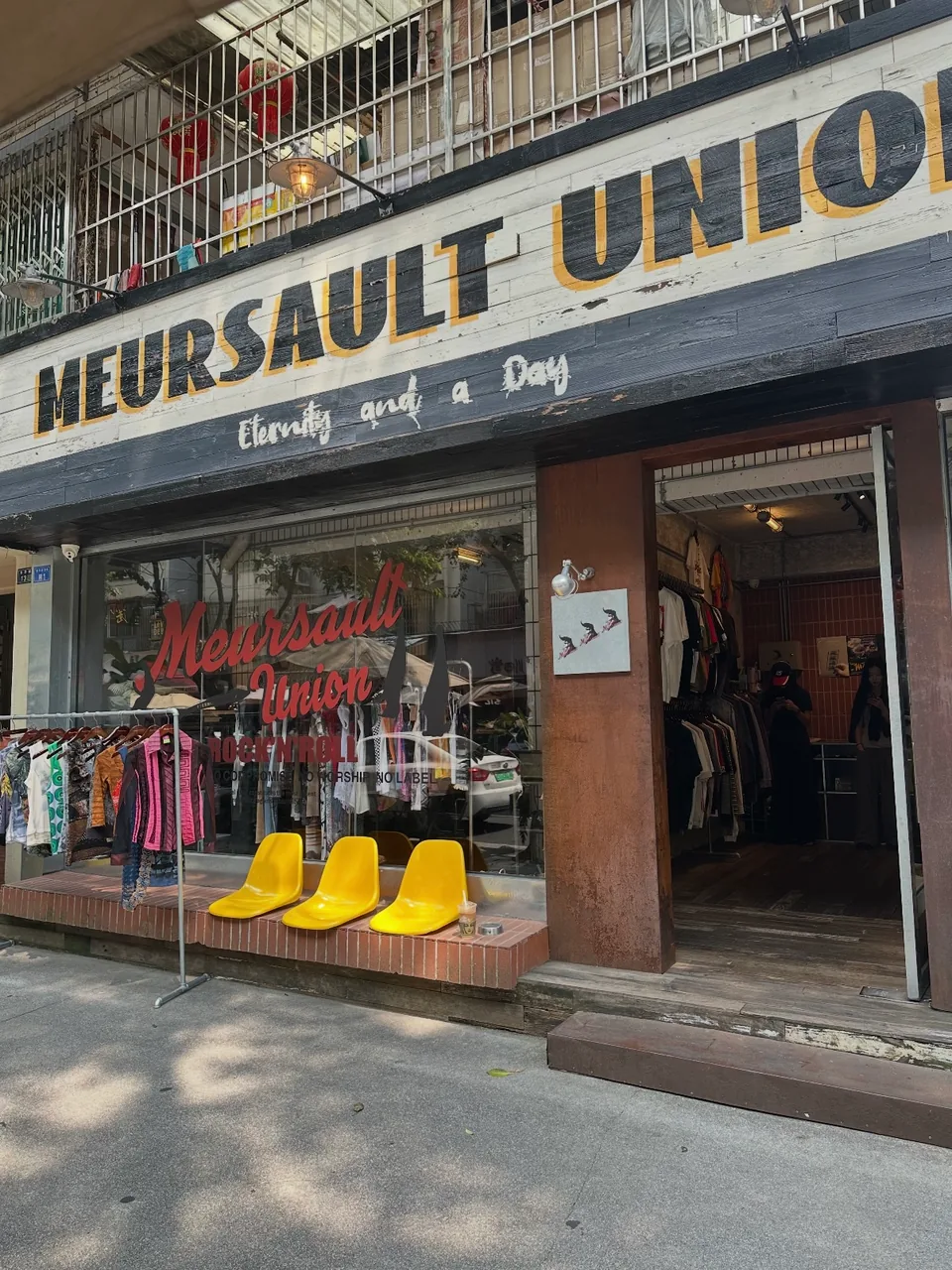 Meursault Union storefront on Fanghua Street, with three yellow seats outside