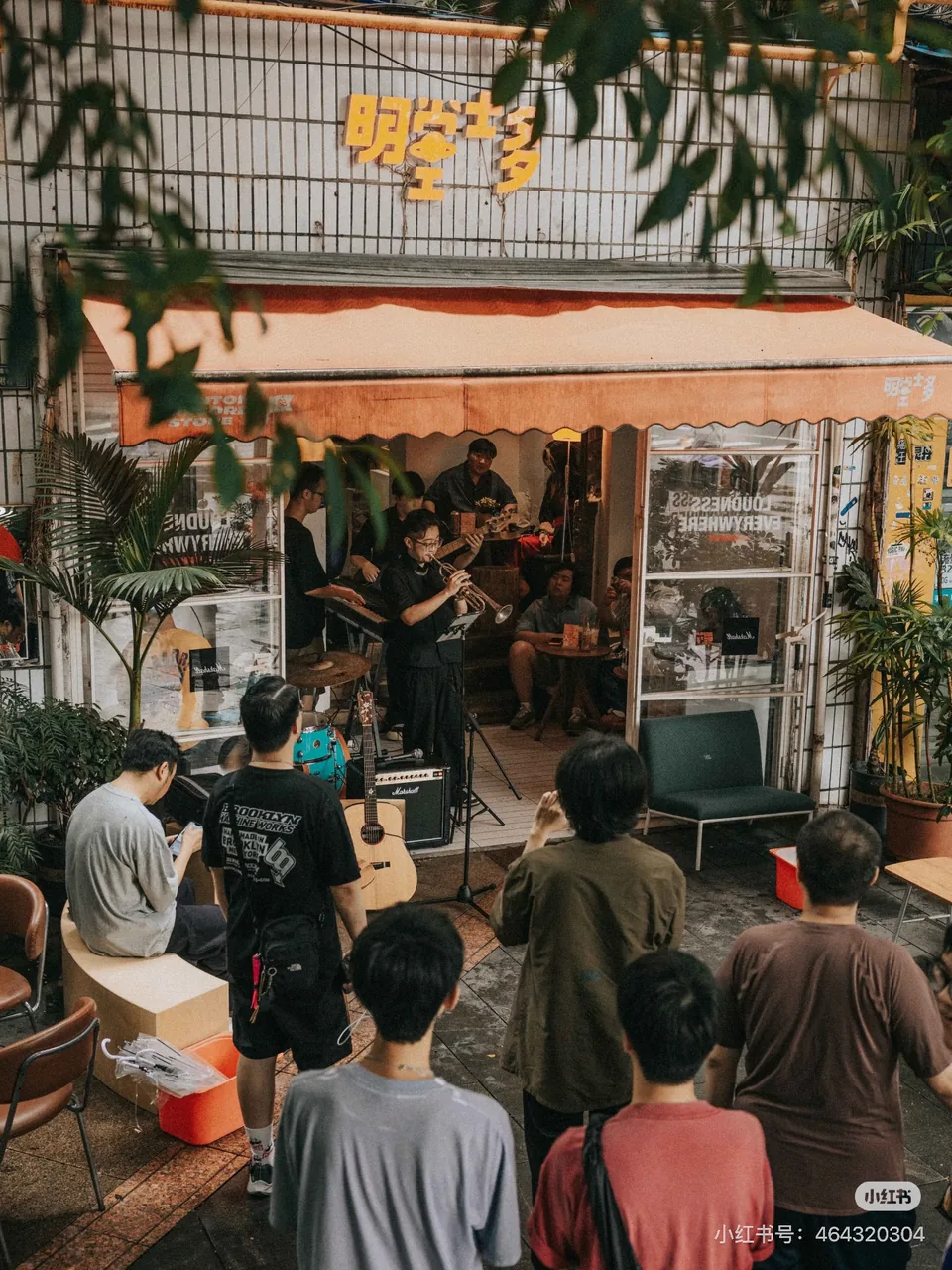 Musicians performing at the entrance to Mintone Record Store, with visitors gathered outside; original RedNote watermark retained